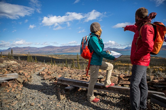 Young couple hiking searching for trail on map